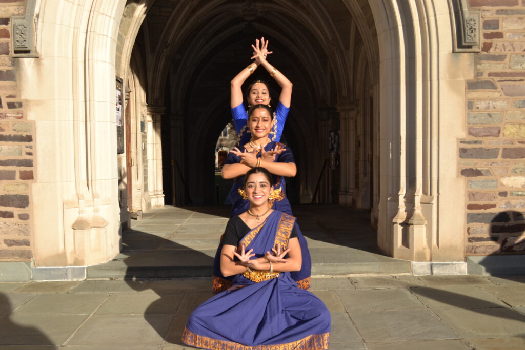 Anika Mehrotra '28, Jaya Choudhary '28, and Samyukta Neeraj '25 in a leveled flower pose