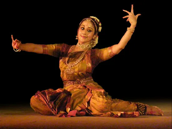 A kuchipudi dancer sitting on the floor using mudras (hand gestures) to convey a story